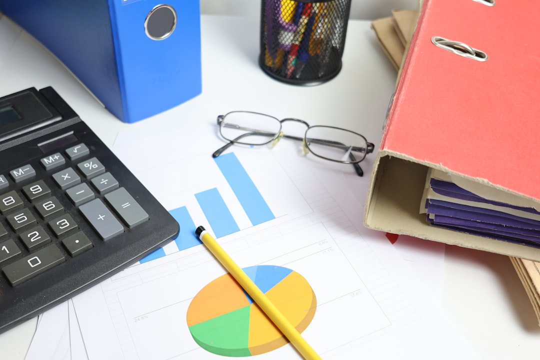 desk-with-calculator-charts-and-binders-fvwy7pbisuo
